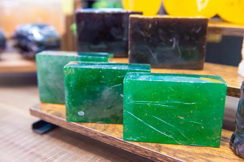Green neem soap bars with visible botanical flecks