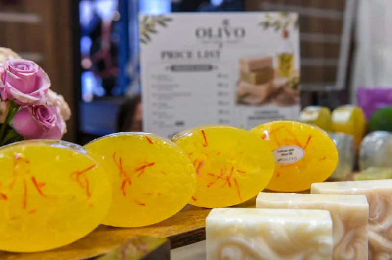 Close-up of OLIVO saffron soap showing the honeycomb texture and saffron threads
