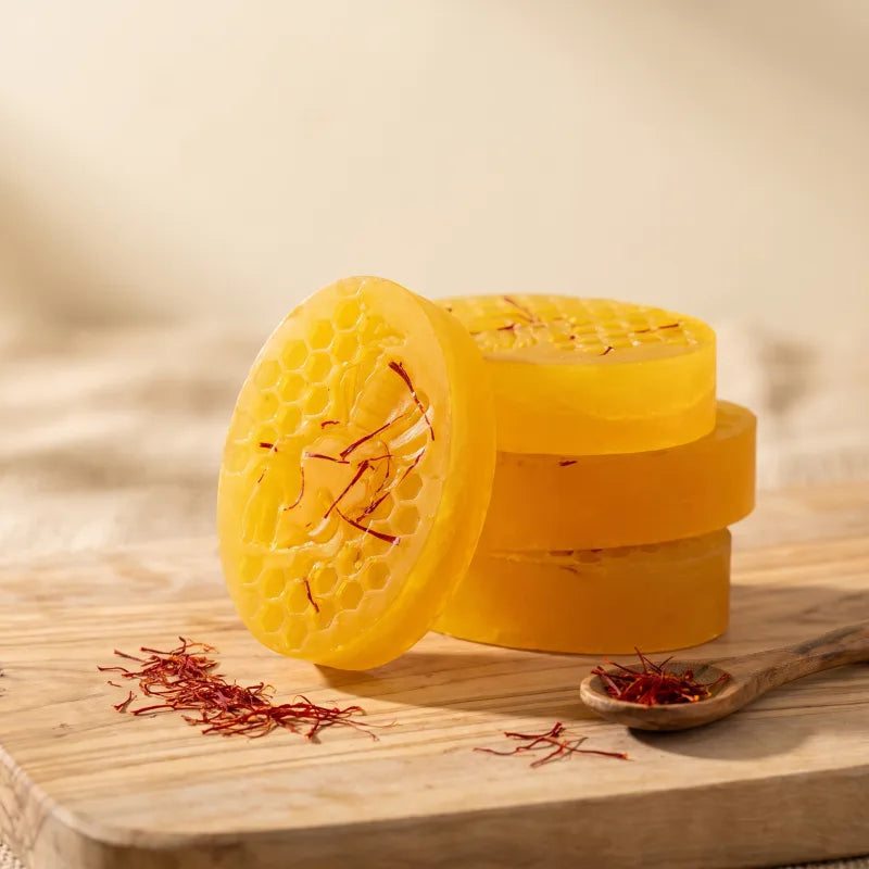 OLIVO saffron soap bars with real saffron threads, photographed in golden beach light