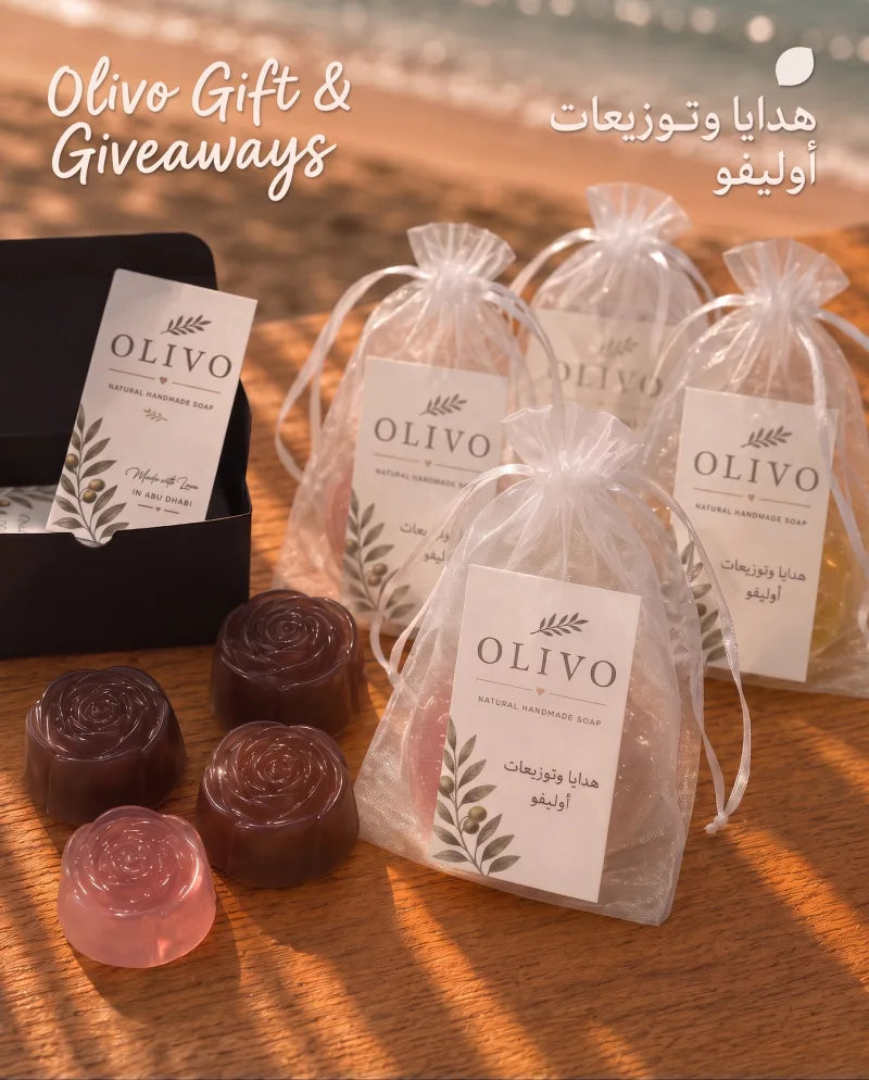 OLIVO gift bags and boxed soap favours on a beach table